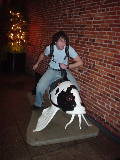 John riding his giant fish to glory